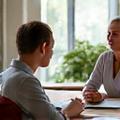 Two people engaged in a thoughtful conversation over coffee